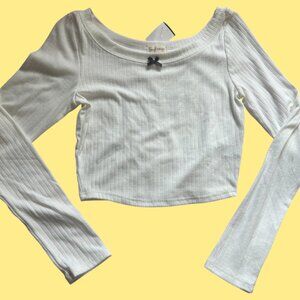 White cropped long sleeve top with black bow detail